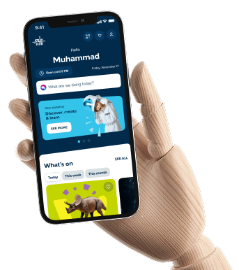 A hand holding a phone showing the ilmi app